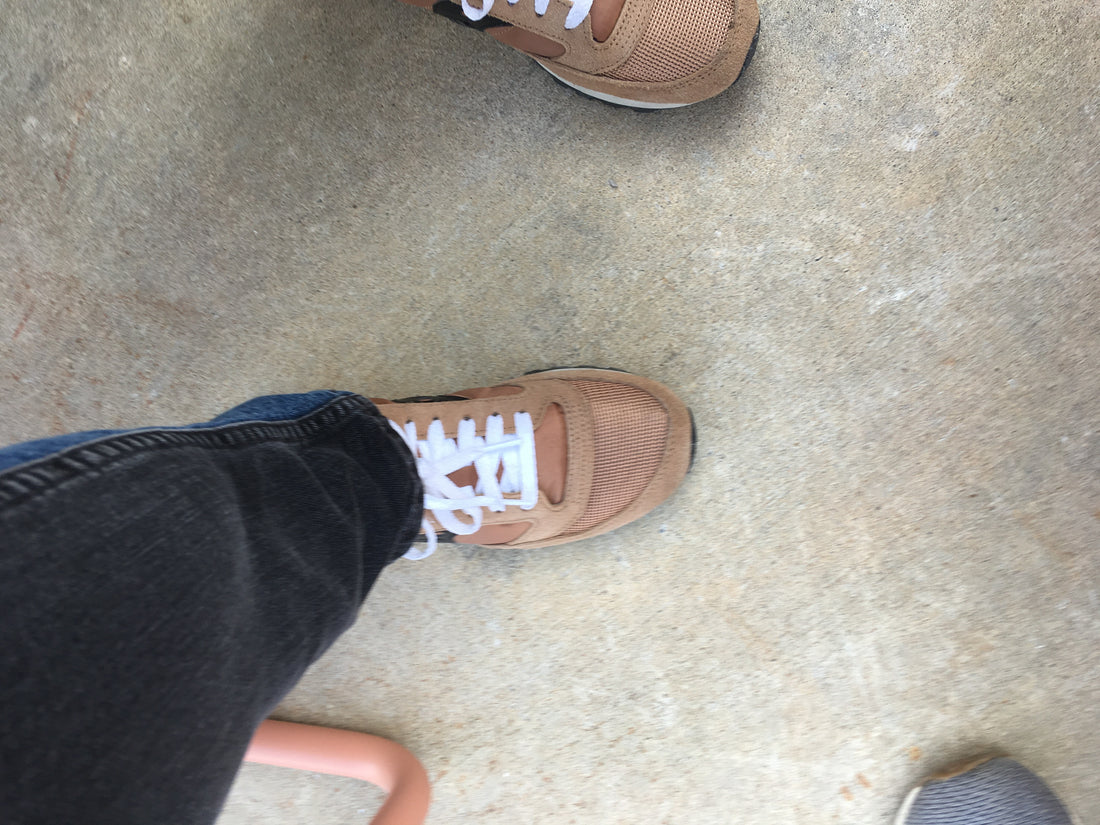 photograph of feet in saucony sneakers